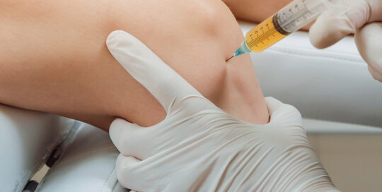 person getting a prp therapy injection in their knee joint