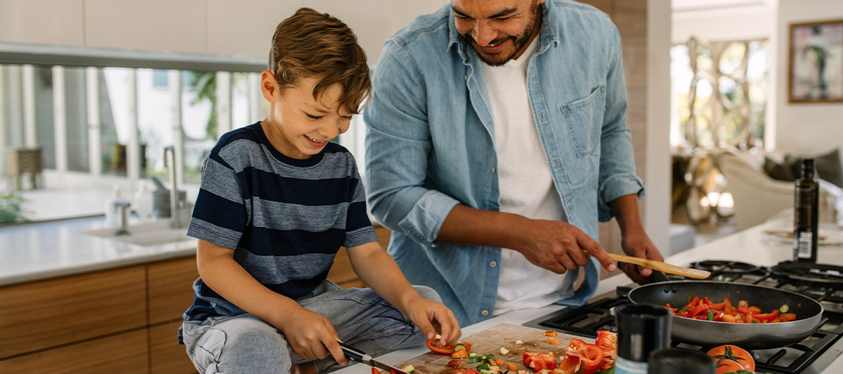 father and son cooking dinner