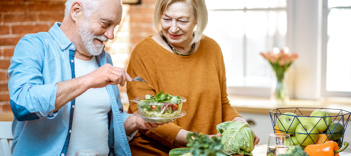 older couple eating a salad together